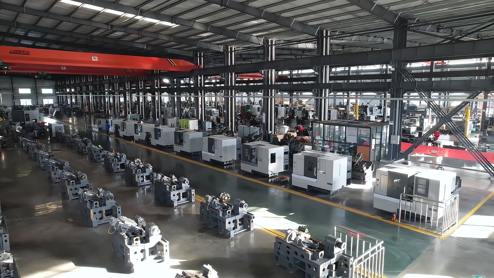 Tiezheng factory workshop image showing CNC machine production areas, assembly activity, and manufacturing environment.