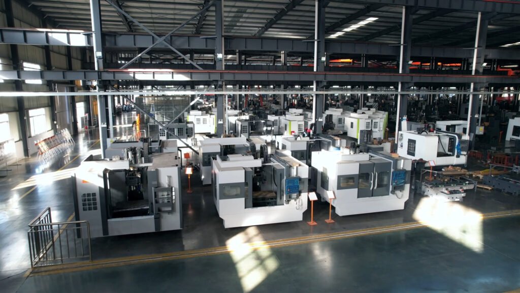 Tiezheng factory workshop image showing CNC machine production areas, assembly activity, and manufacturing environment.